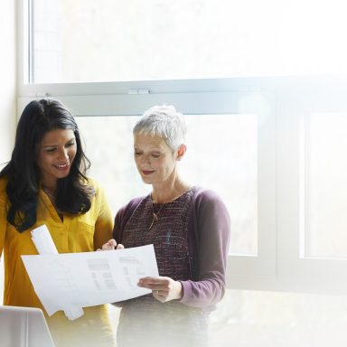 Women discussing paper works