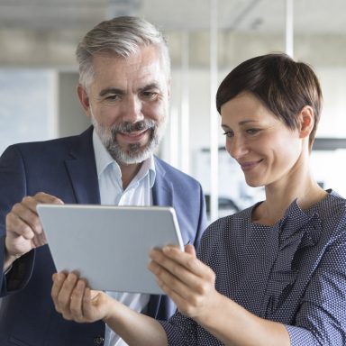 business-man-and-woman-with-tablet-in-office