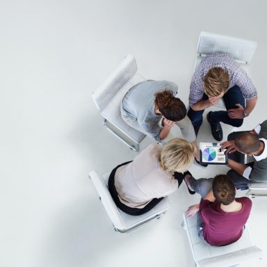 Businesspeople using digital tablet together