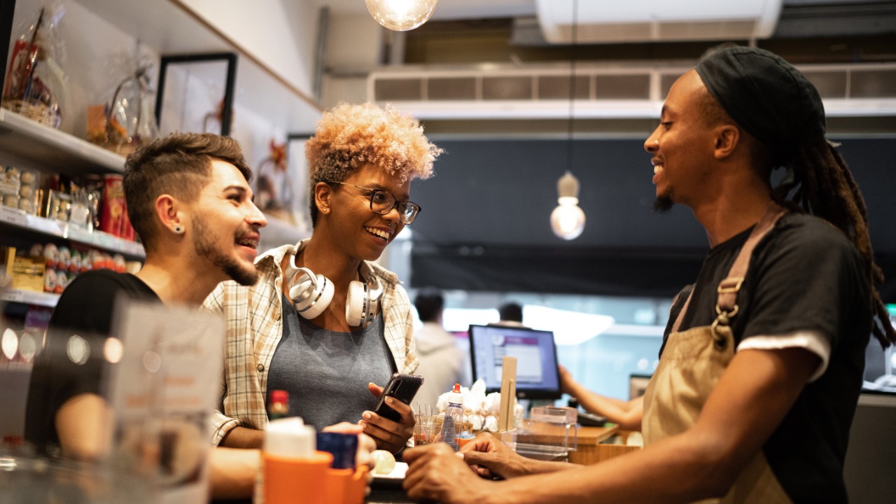 Coworkers talking at coffee shop