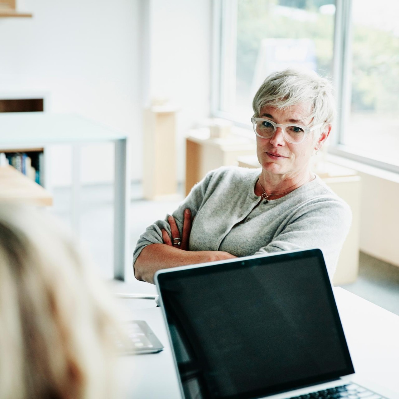 Woman listening in a meeting at a conference table