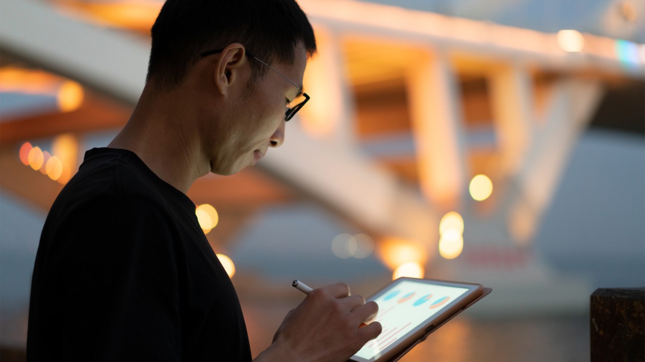 Man using tablet at night