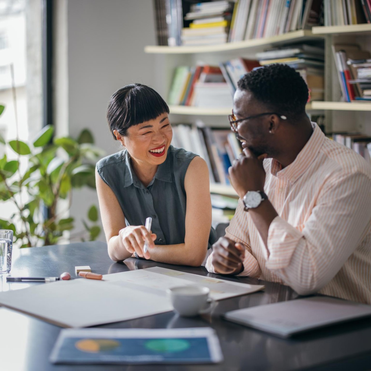 smiling woman consulting male coworker