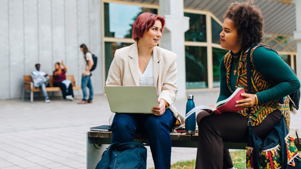 female-students-studying-together-outside