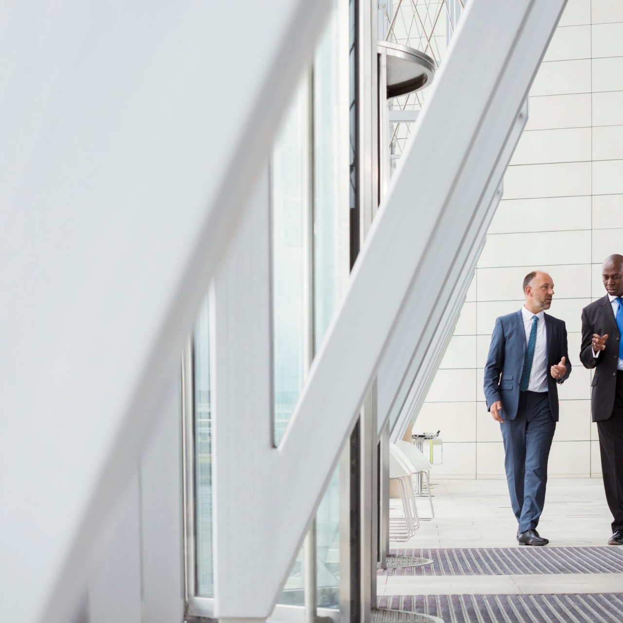 Businessmen walking with luggage at airport