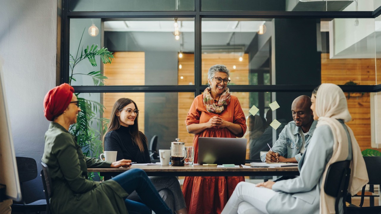 Group of cheerful business professionals working as a team in a multicultural workplace.