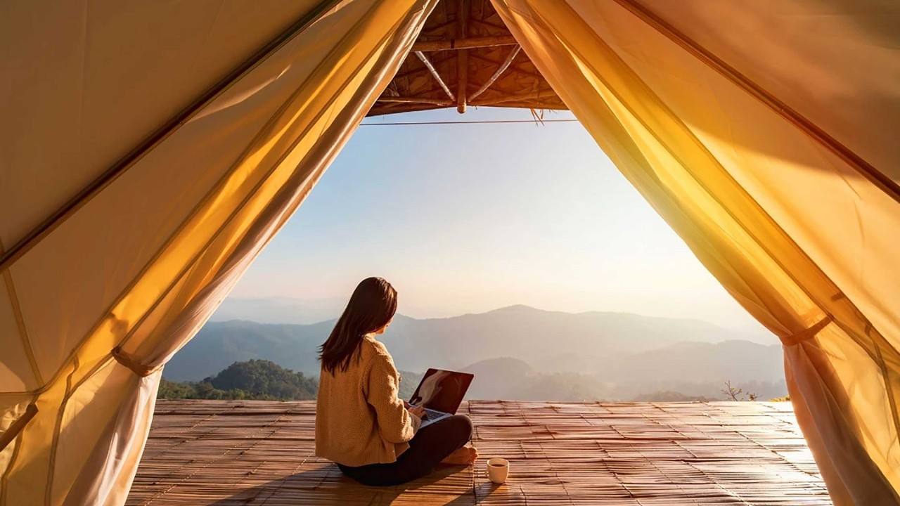 Young woman freelancer traveler working online using laptop